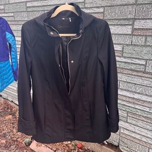 Calvin Klein Black Hooded Jacket / Trench Coat. Stylish form and design accents.